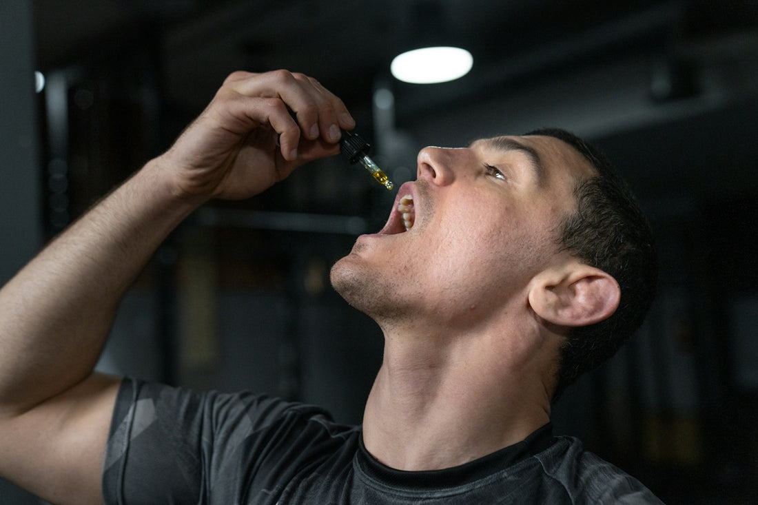 Man taking liquid from dropper into mouth