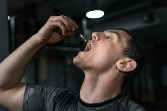 Man taking liquid from dropper into mouth